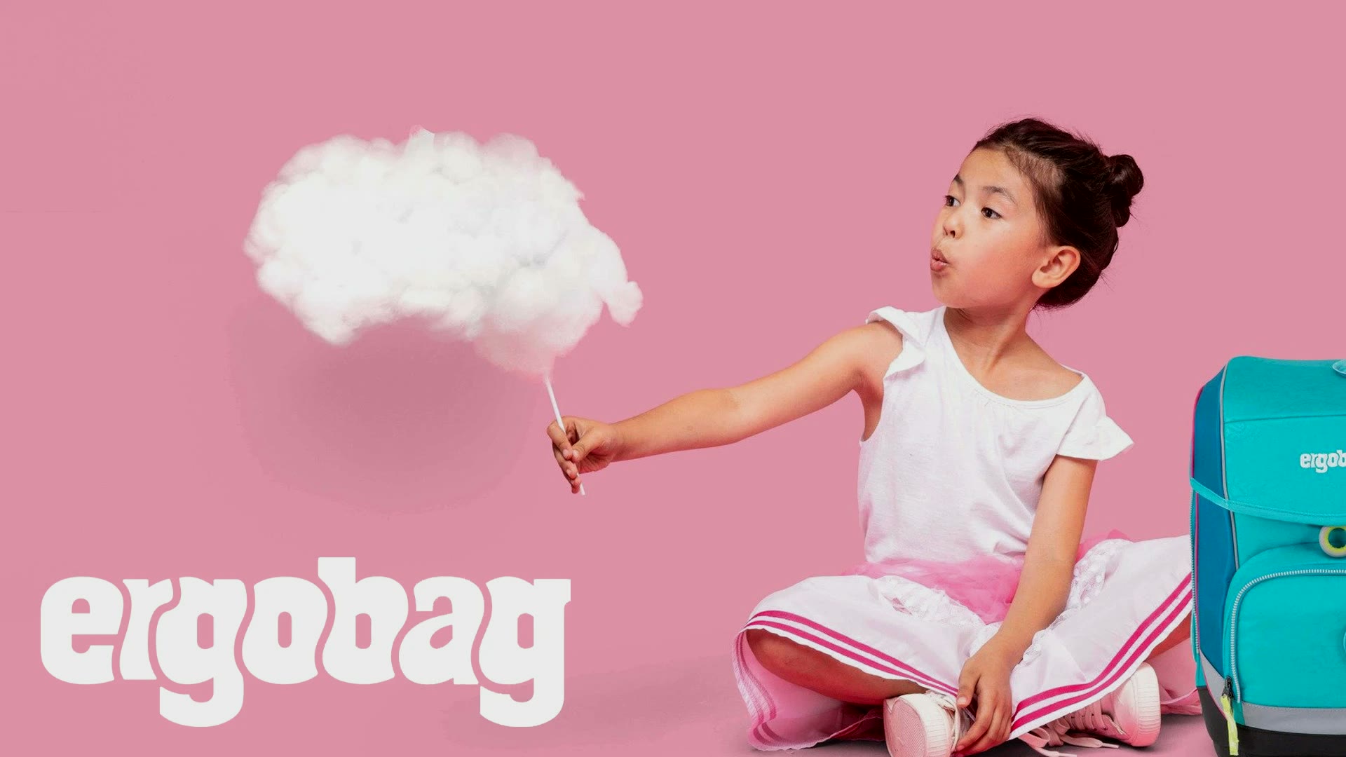 ergobag, Keyvisual: Mädchen mit Wolke am Stiel neben ihrem Schulrucksack